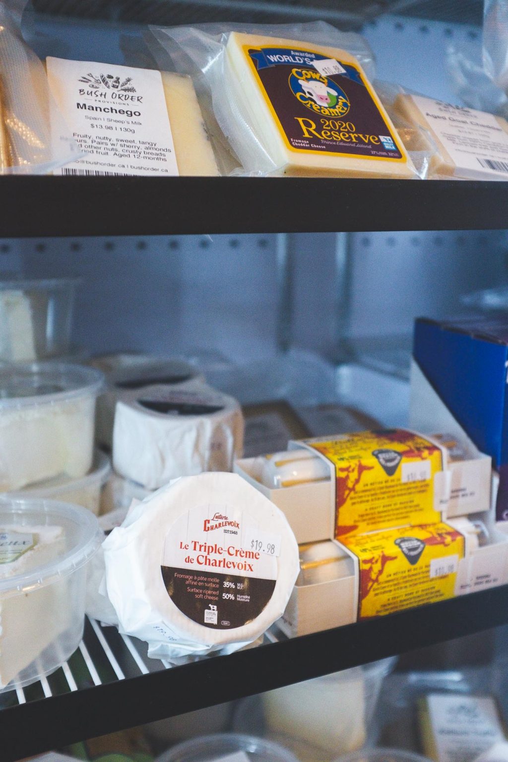 The Farm Store cheese fridge stocked with Canadian and European cheeses